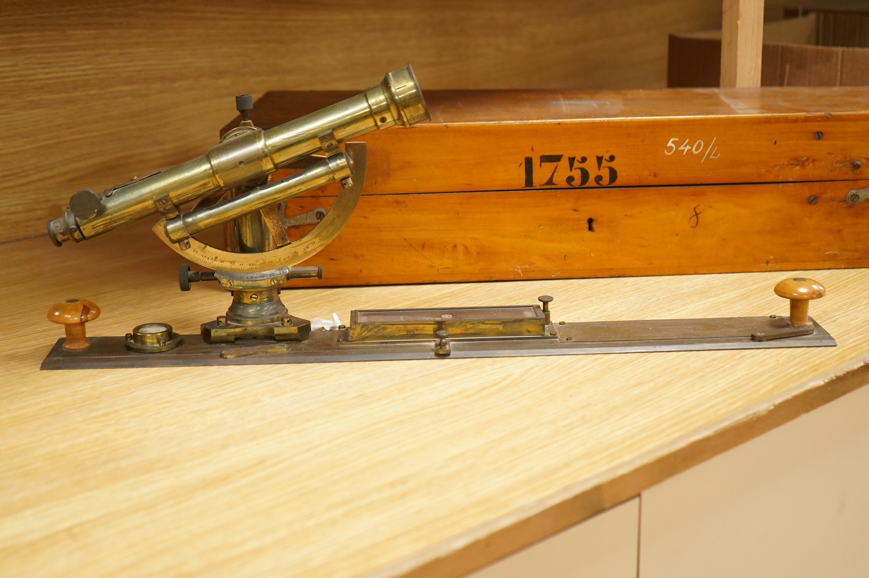 A German brass alidade by F. Sartorius, Göttingen, number 1755, 58.5cm wide, contained within a fitted birch case with applied maker’s label and other reference markings, the case; 63cm wide, 14cm high, 25cm deep at the